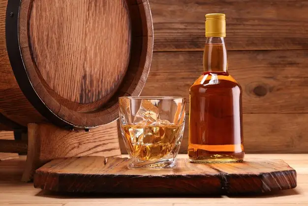 Scotch-whiskey-bottle-and-old-barrel-_-Premium-Photo
