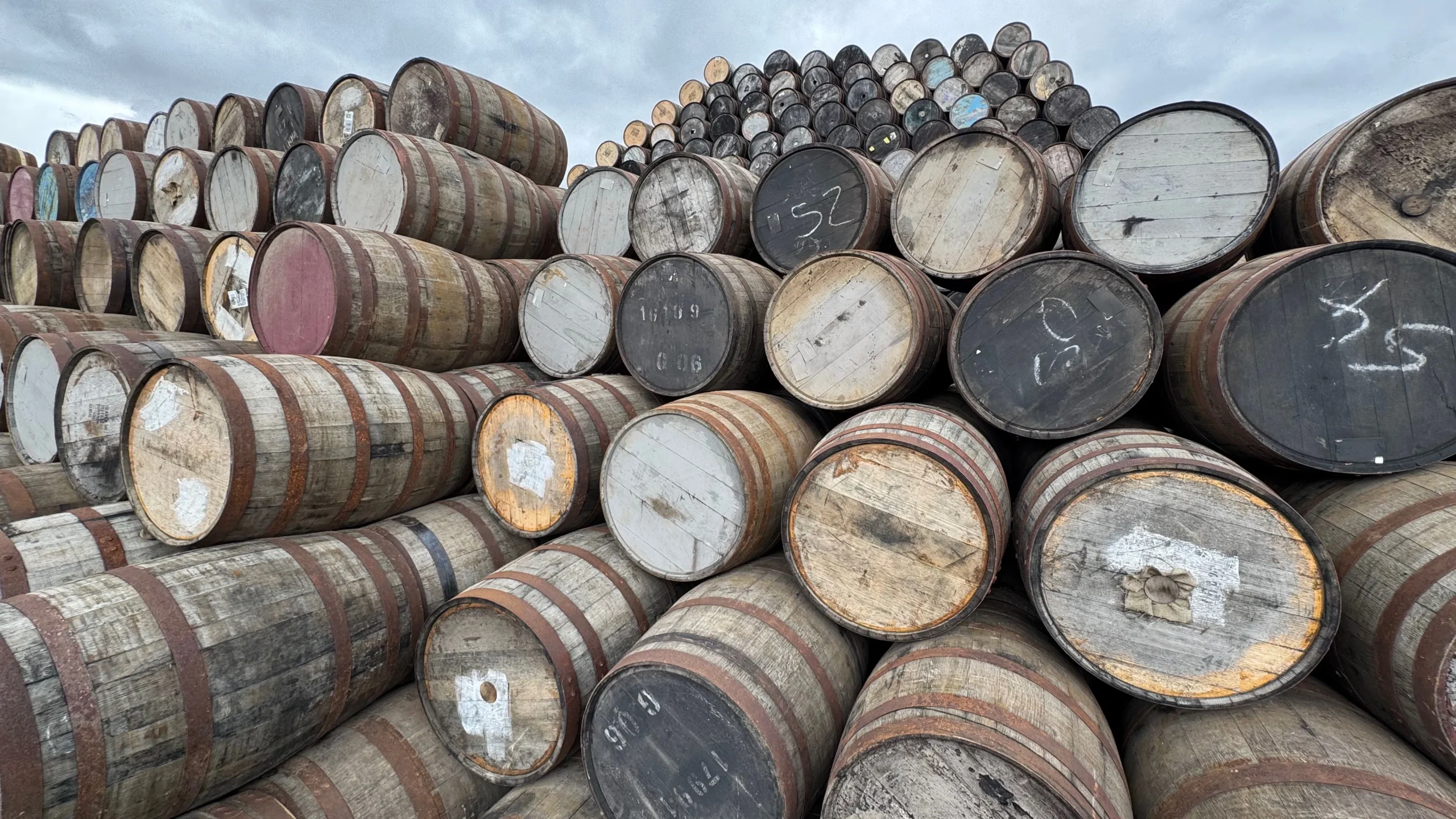 Whiskey barrels stored in a distillery aging warehouse