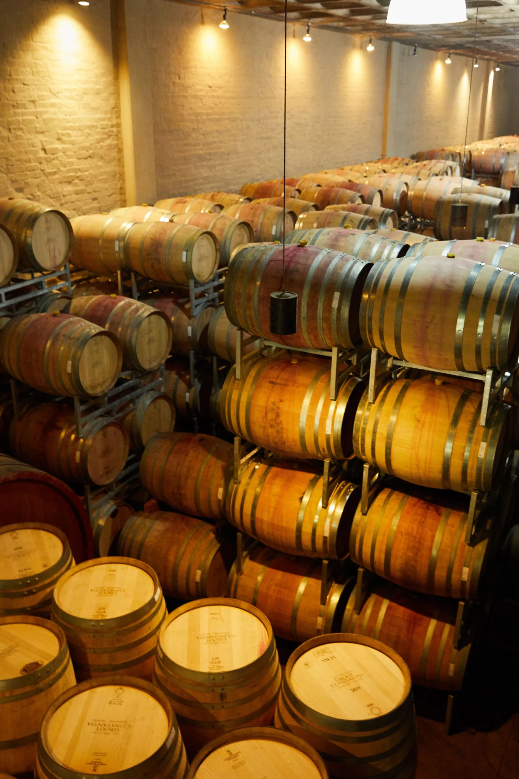 Inspecting a used whiskey barrel for condition, leaks, and quality before purchasing.